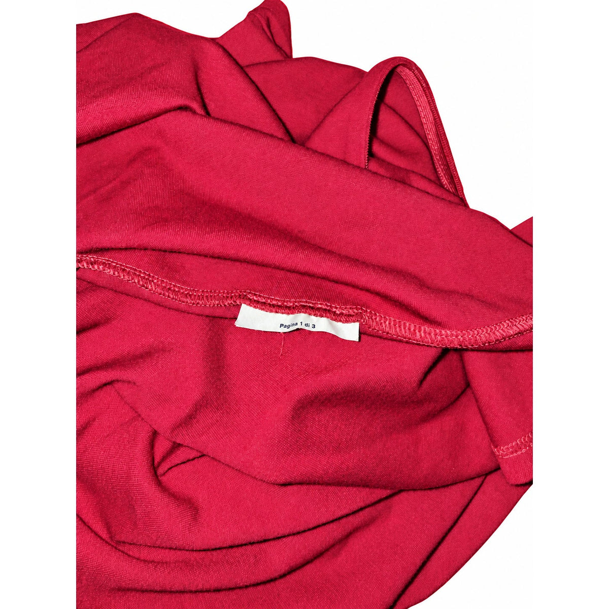 Inside seam and partial label reading Pagina 1 di 3 on the RED Valentino dress; size and fibers are not shown.