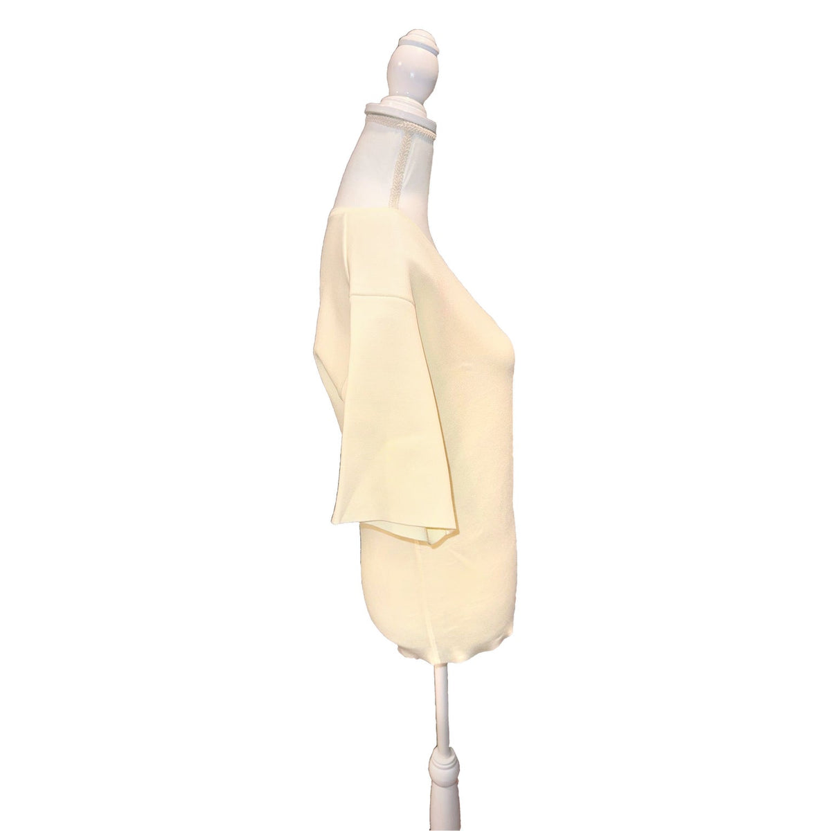 Side view of the ivory ANINE BING Damion sweater, showing the dropped shoulder and short sleeve.
