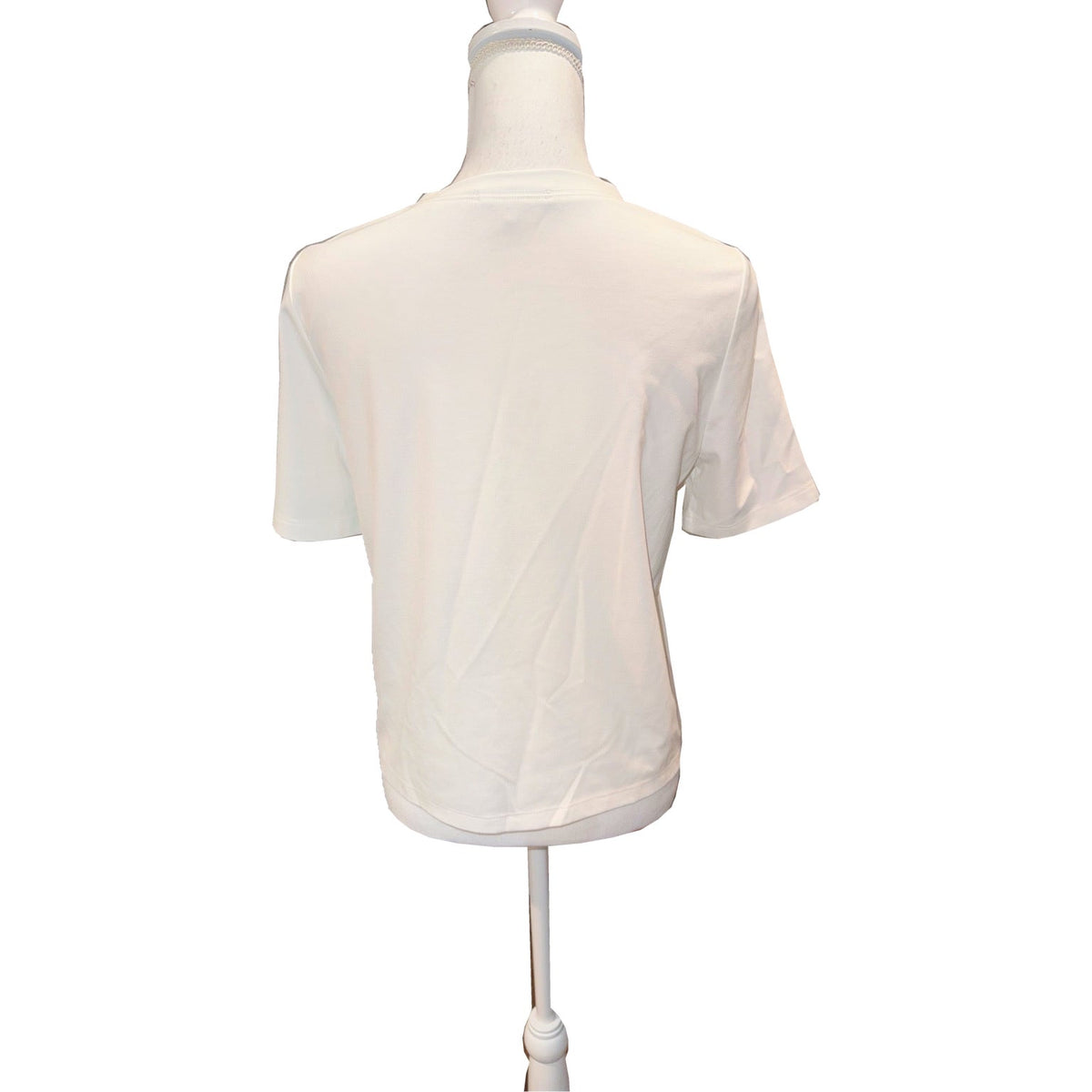 Back of the ivory MILLY T-shirt with short sleeves, round neckline and straight hem.