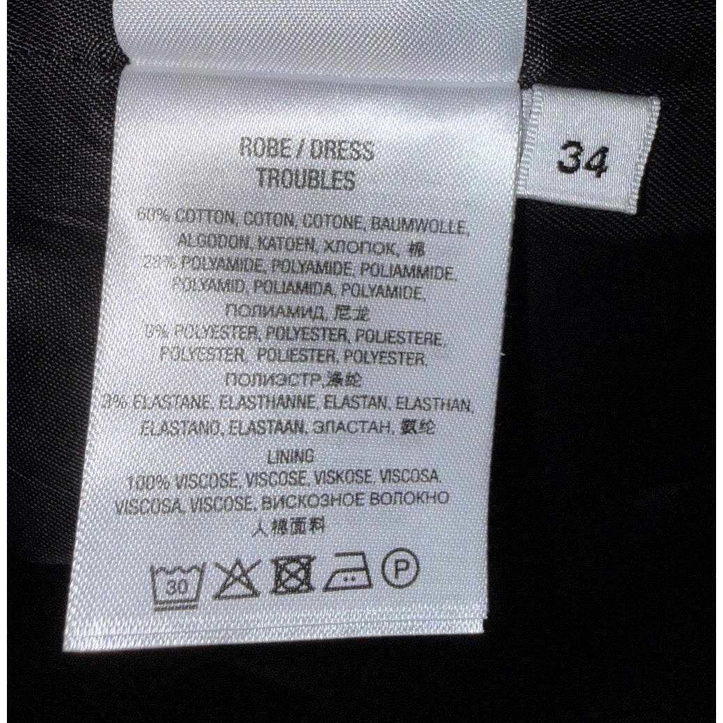 Essentiel Antwerp Troubles fabric and care label with size 34, fiber percentages and 30°C wash symbol.