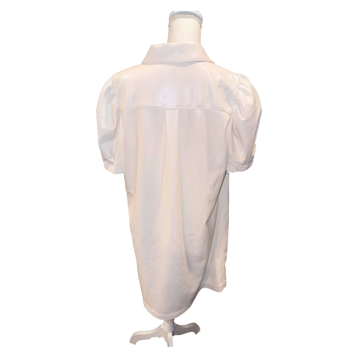 Back of the ivory Alice + Olivia faux leather shirtdress with shoulder yoke and gathered short sleeves.