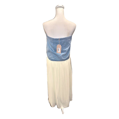 Back of the MESHKI Tully denim and chiffon maxi skirt displayed on a mannequin, with hangtag attached.