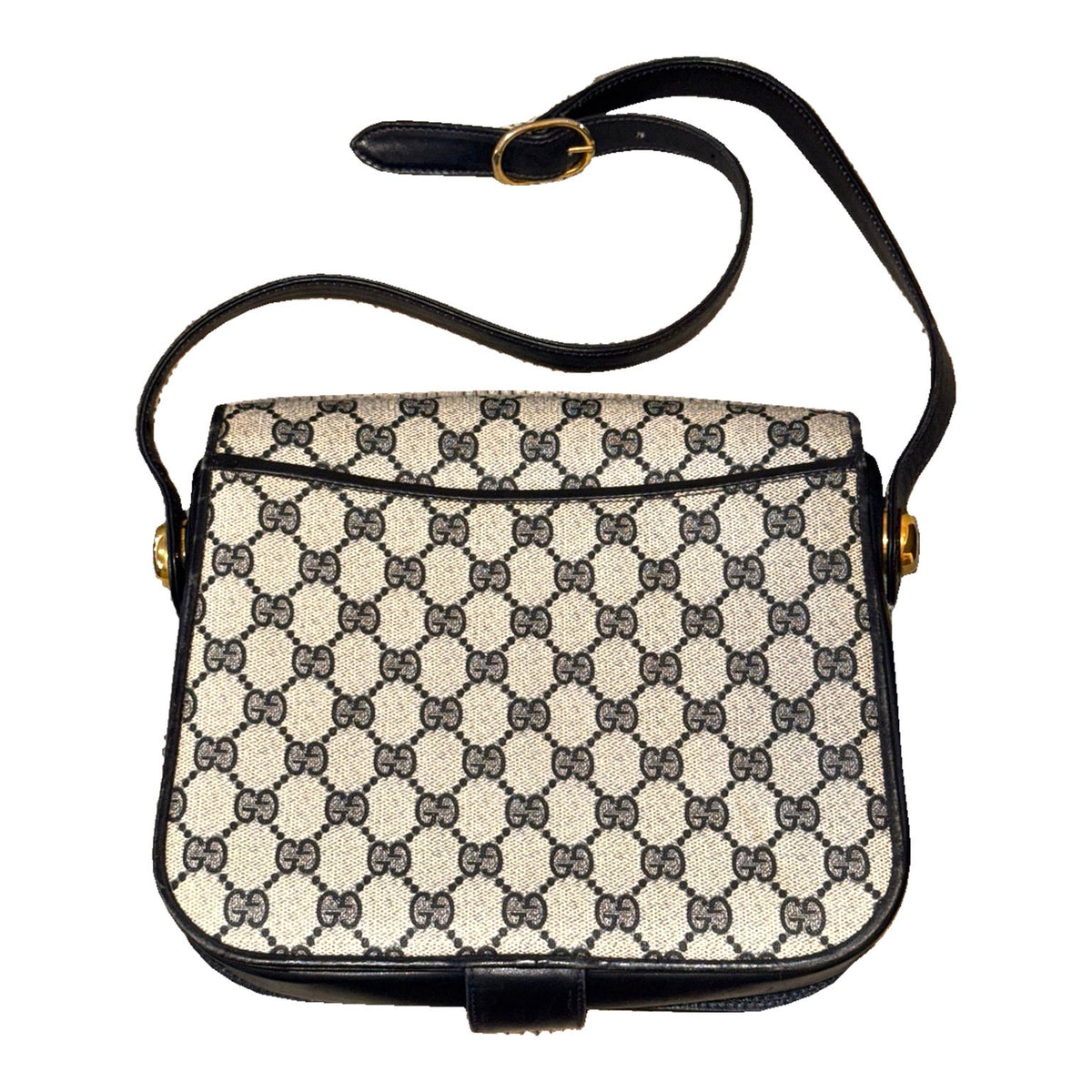Back of the Gucci GG monogram shoulder bag, showing the rear slip pocket and adjustable buckle strap.