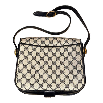 Back of the Gucci GG monogram shoulder bag, showing the rear slip pocket and adjustable buckle strap.