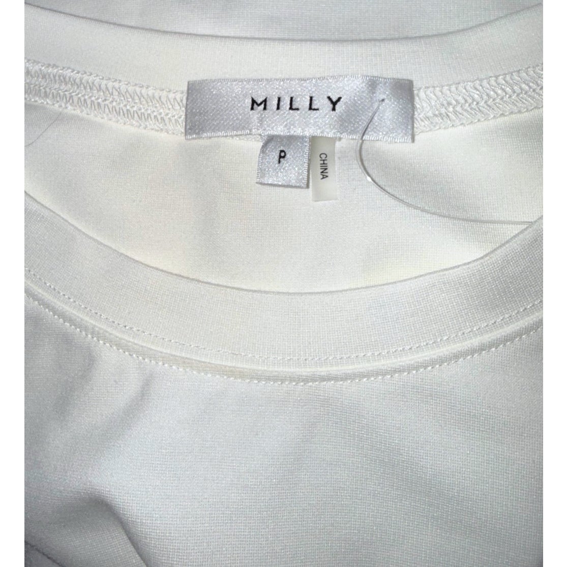 MILLY brand label with size P and China tags inside the ivory T-shirt.