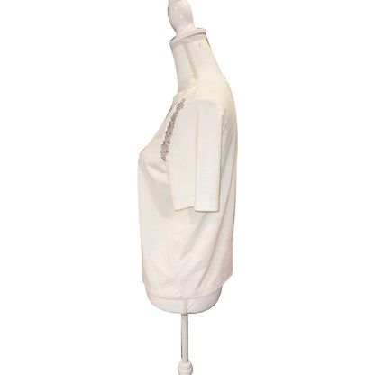 Side view of the ivory MILLY T-shirt, showing short sleeve and the sparkling shoulder detail.