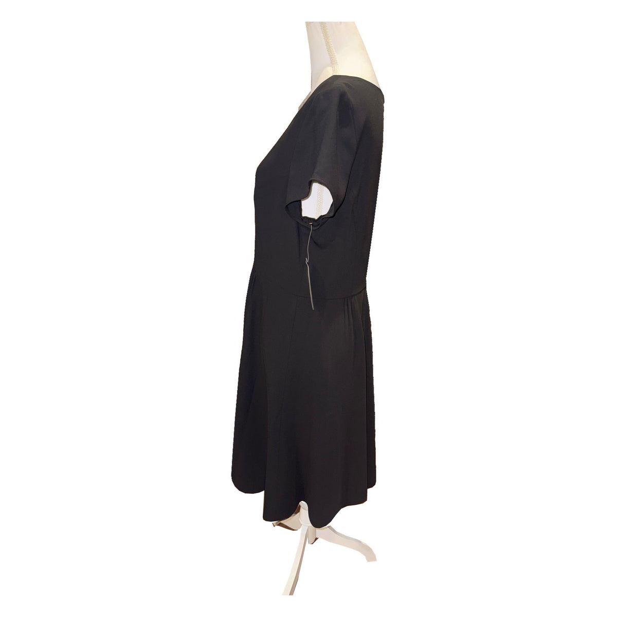 Side view of the black Pendleton dress, showing short sleeve, waist seam and flared skirt.