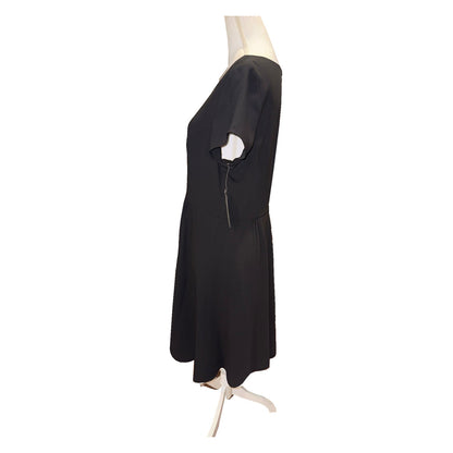 Side view of the black Pendleton dress, showing short sleeve, waist seam and flared skirt.