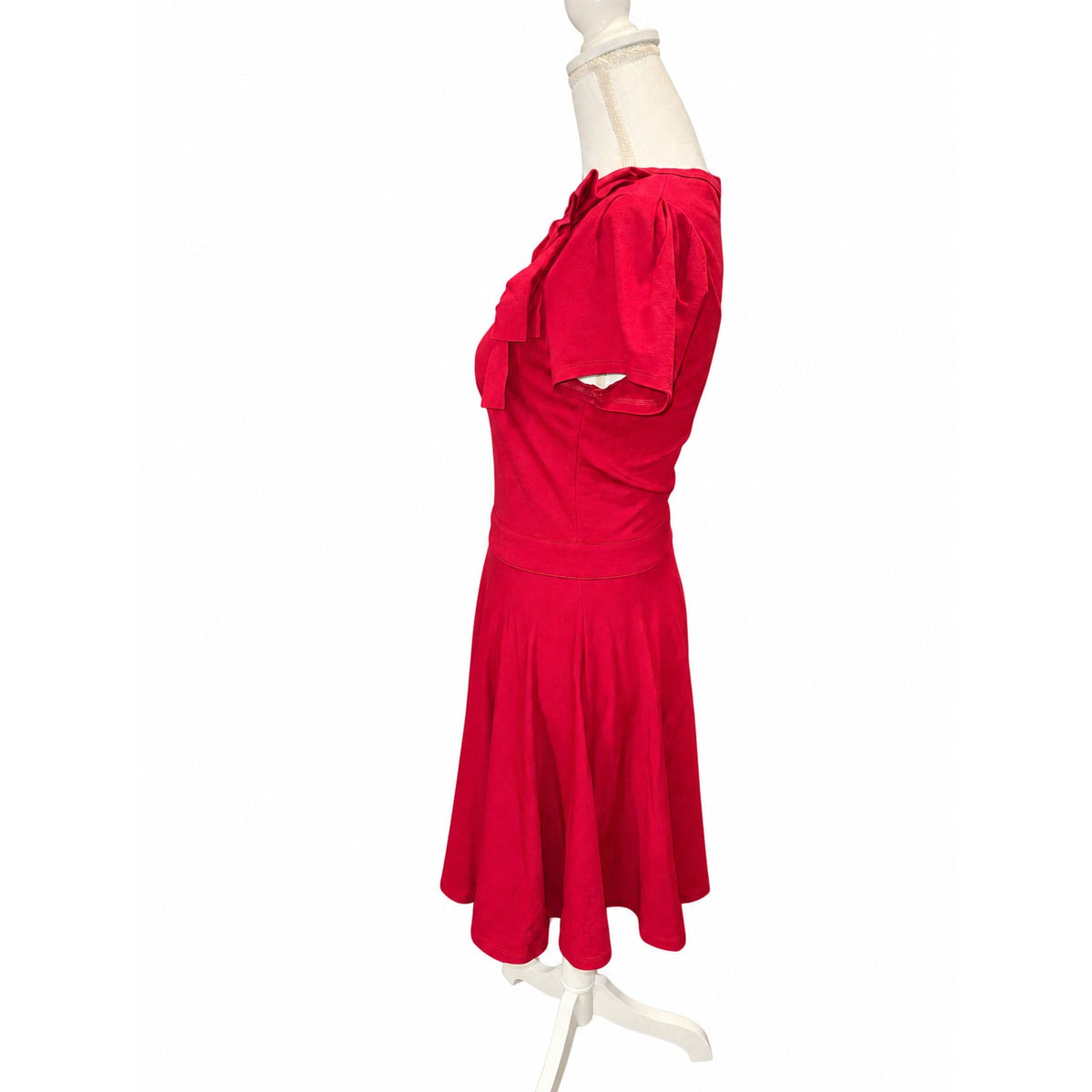 Side view of the RED Valentino dress with short puff sleeve, layered shoulder bow and flared skirt.