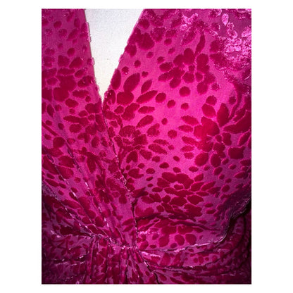 Close-up of the Veronica Beard dress with floral burnout velvet, V-neckline and gathered twist at the waist.