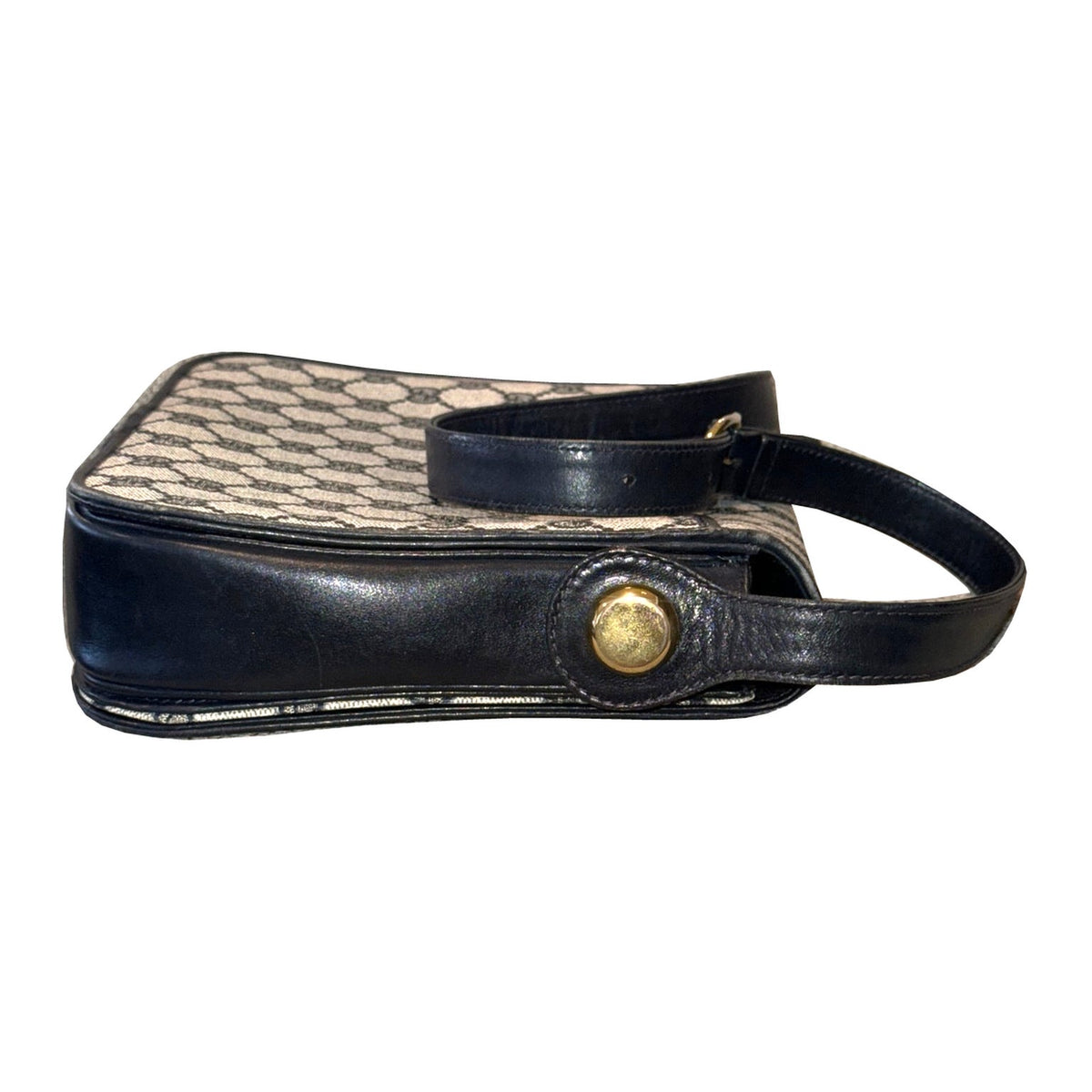 Opposite side of the Gucci shoulder bag with strap, round gold-tone attachment and visible piping wear.